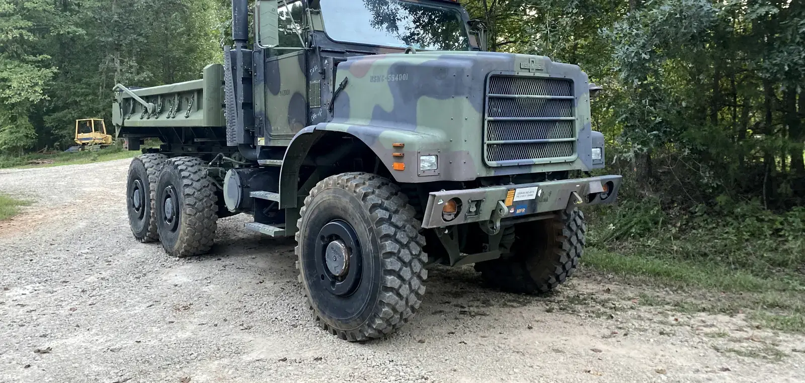 MTVR dump truck with hard cab parked on gravel